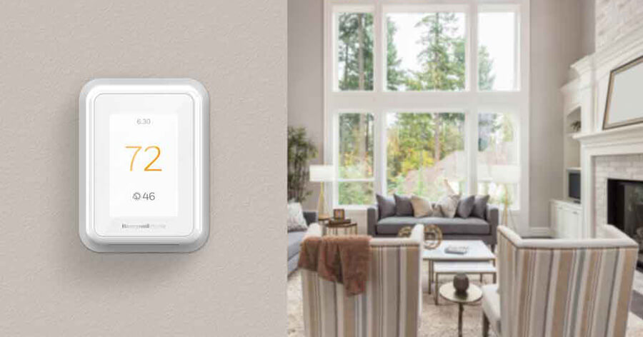 A cozy living room with a smart thermostat on the wall.